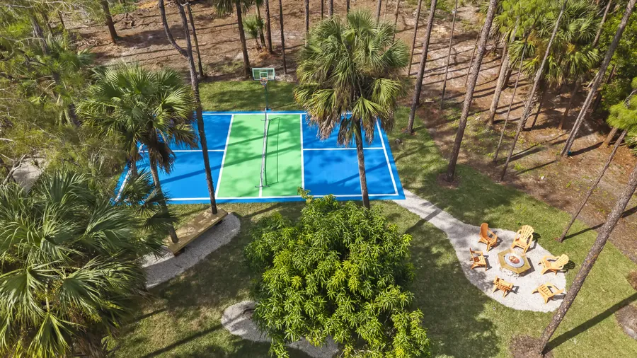 Aerial of pickleball/basketball court beside the Adirondack fire pit circle, The Naples Retreat, Naples FL