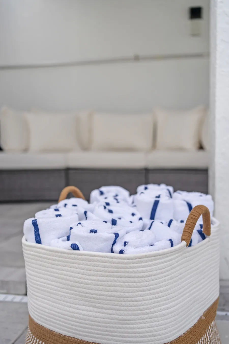 Basket of rolled beach towels ready by the pool, The Naples Retreat, Naples FL