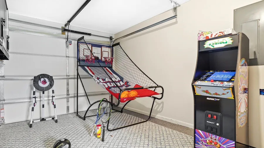 Garage game room with arcade cabinet and basketball shootout machine, The Naples Retreat, Naples FL