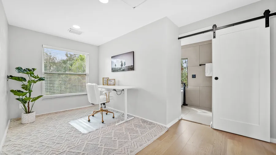 Bright home office with sit-stand desk next to the primary bathroom, The Naples Retreat, Naples FL