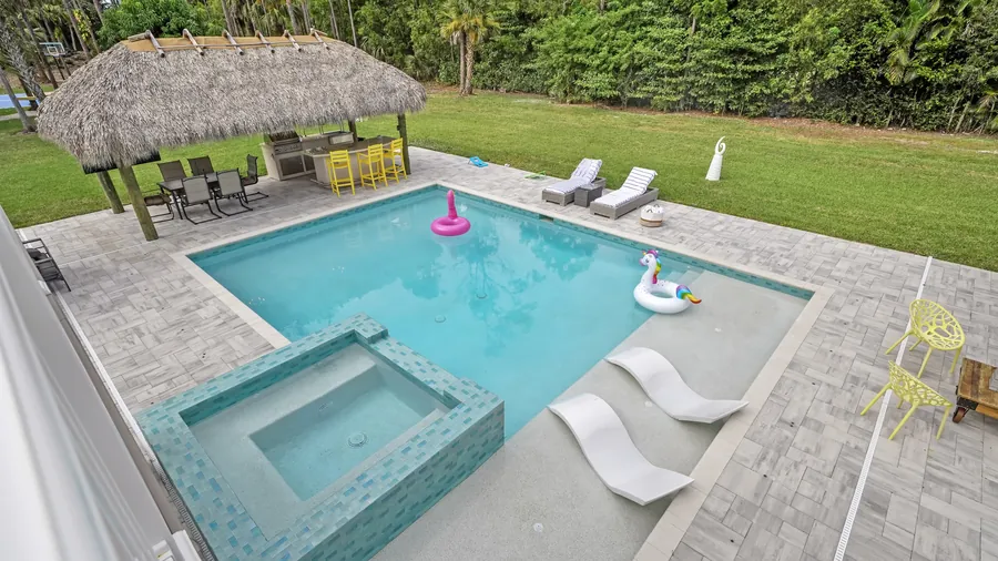 Pool, raised spa and sun shelf seen from the upstairs balcony, The Naples Retreat, Naples FL
