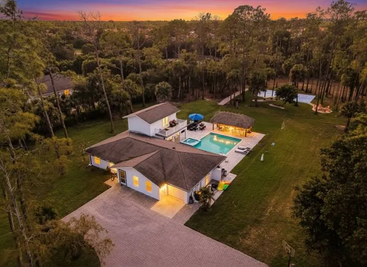 Aerial view of the lawn and pool at dusk