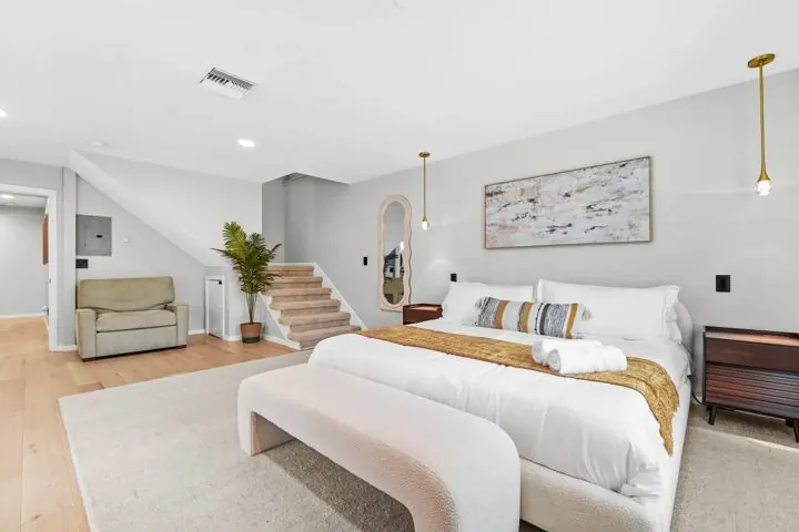 Primary bedroom with king bed and upholstered bench
