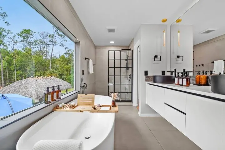 Primary bathroom with double vanity and tub