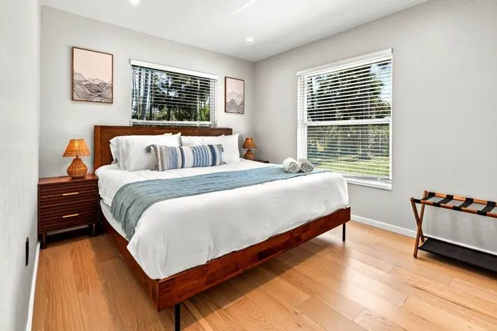 Bright bedroom with king bed and two windows